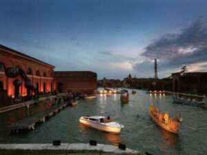 Venetian boats illuminated with lights for the Naumachia Ball on the canal