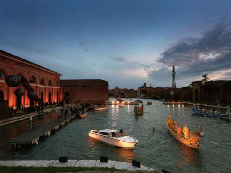 Venetian boats illuminated with lights for the Naumachia Ball on the canal