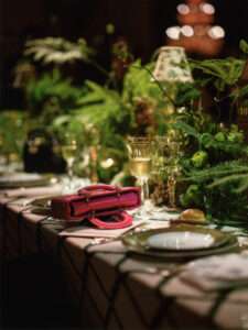 Close-up of elegantly set table at Dior event with intricate décor