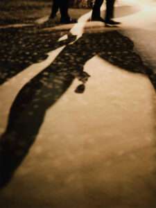 Refined silhouettes of Dior guests walking through the event space at Venice Arsenal