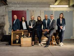 Group of Krug Champagne tasting experts posing together in a vibrant setting