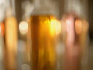 Blurry close-up of Krug Champagne bottle with golden hues and vibrant reflections