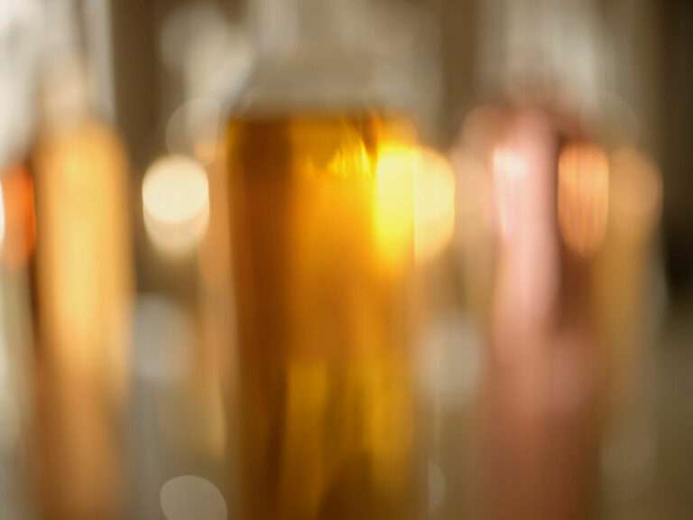 Blurry close-up of Krug Champagne bottle with golden hues and vibrant reflections