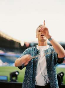 Thomas Roussel conducting classical orchestra at PSG stadium for Ligue 1 closing ceremony