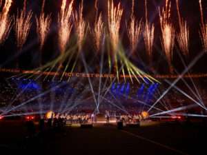 Thomas Roussel orchestrating performance for Ligue 1 closing ceremony, surrounded by fireworks